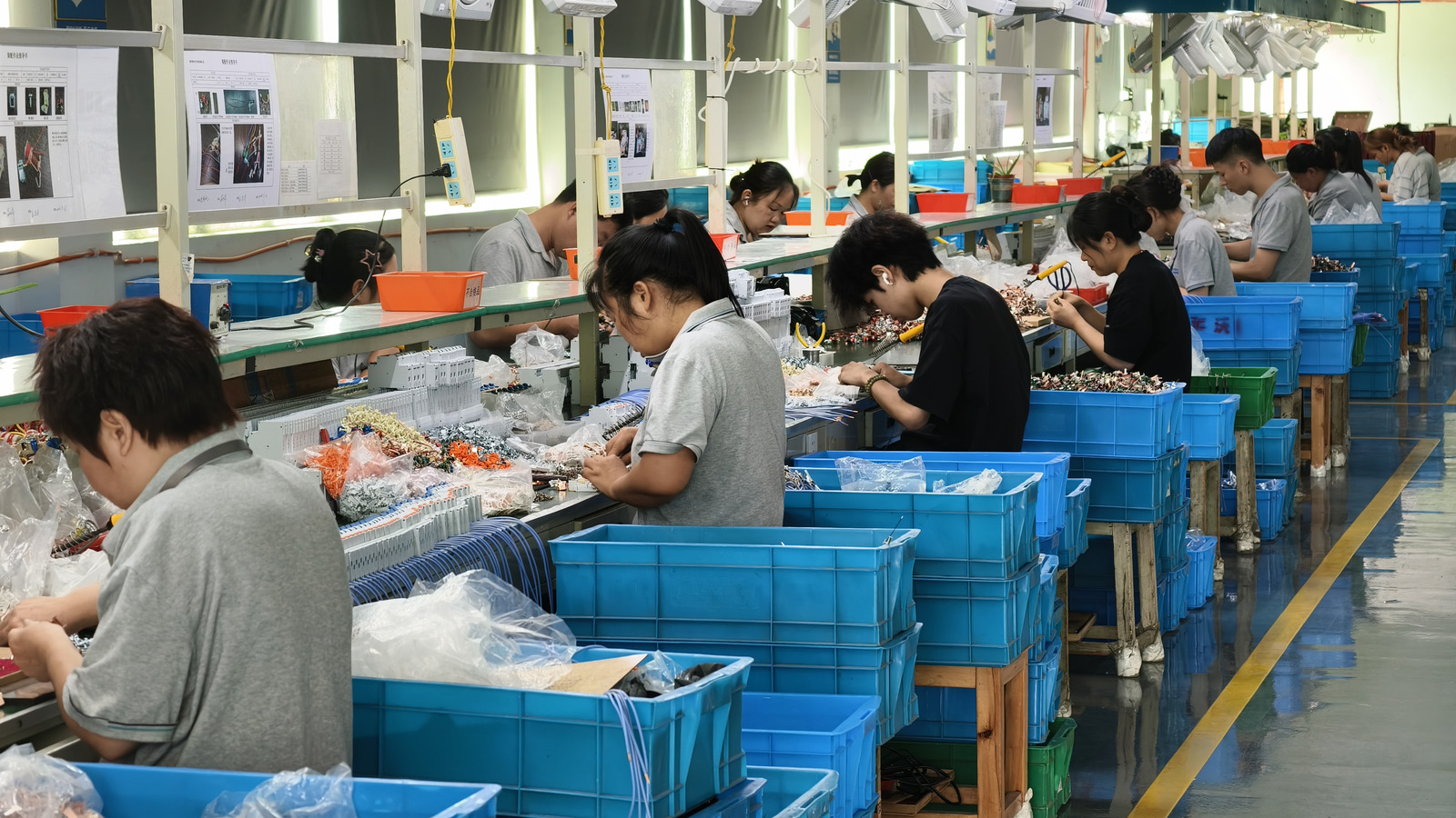 LAIWO circuit protection assembly line, with devices being built and boxed along the bench