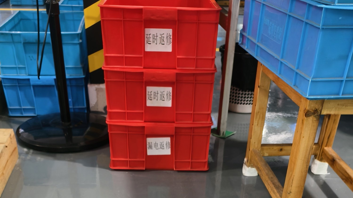 Non-conforming units held in labelled quarantine crates, separated by defect type