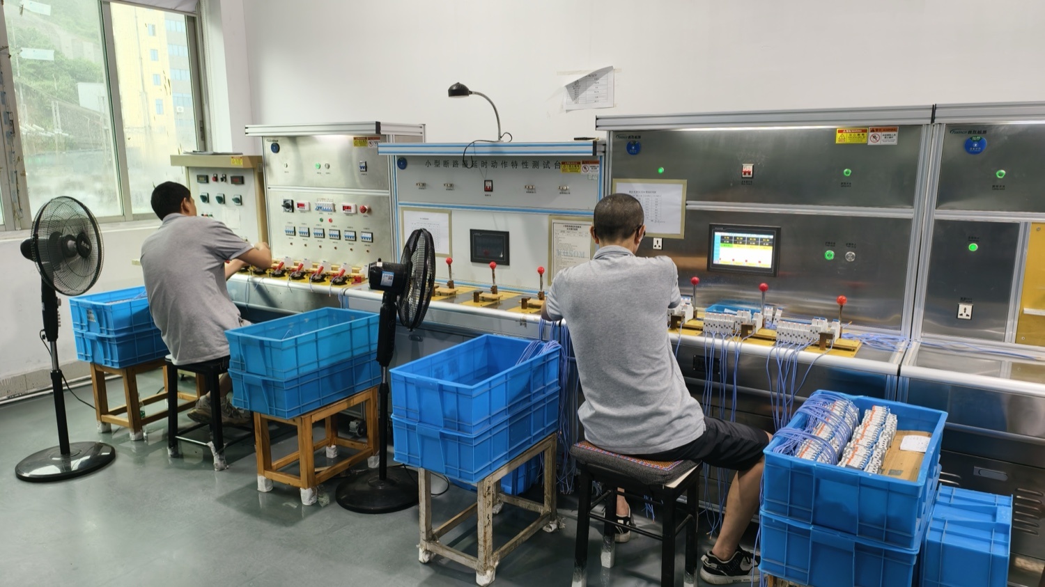 Operators working in-process checks at adjacent verification stations