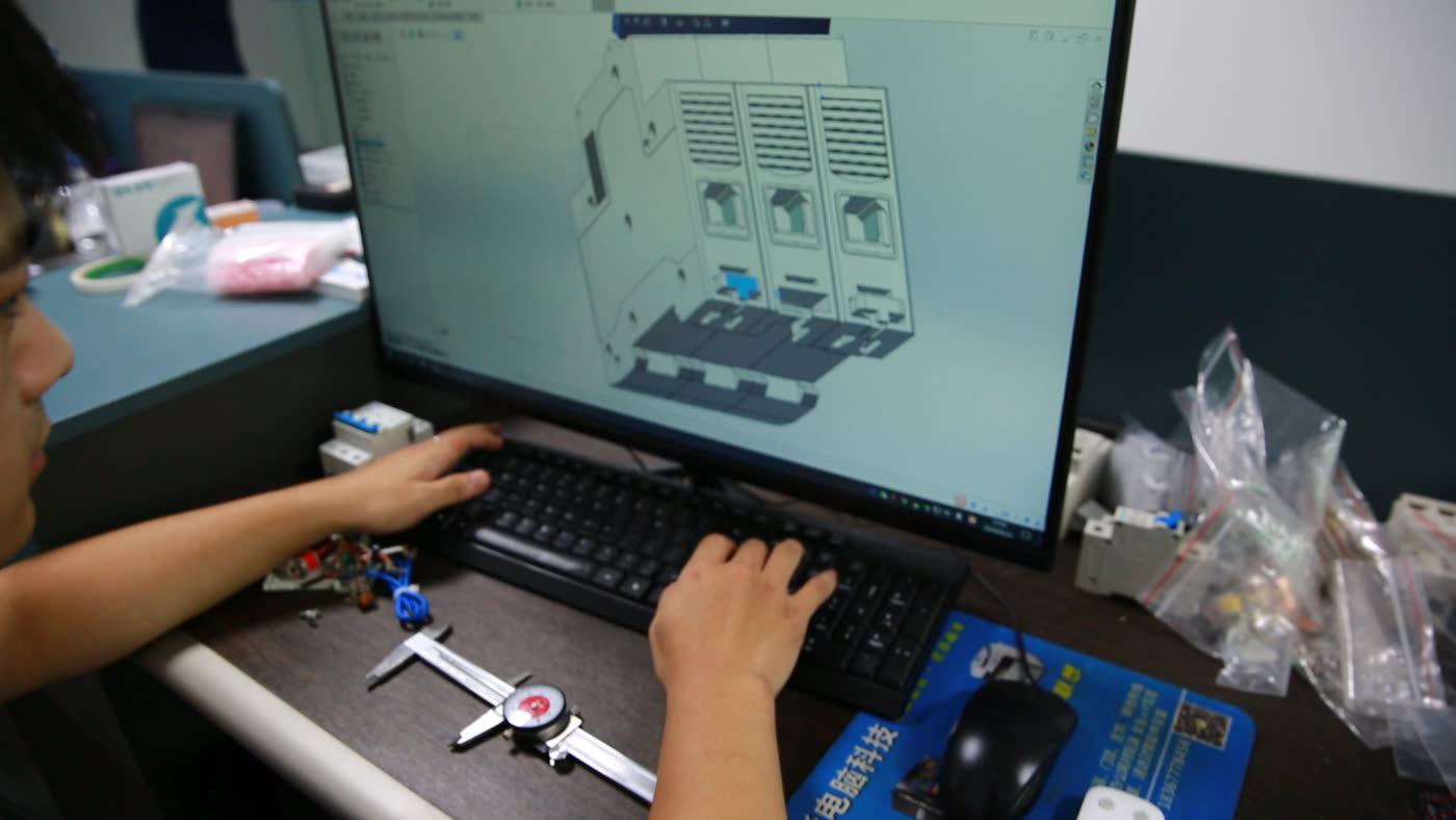 LAIWO engineer developing a circuit breaker design at a CAD workstation